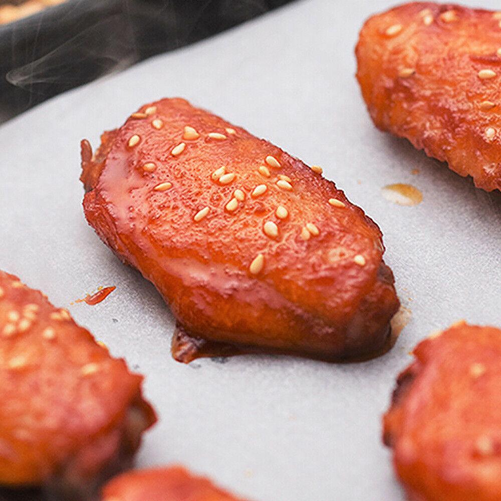 Glazed sesame chicken wings on Your Brand microwave oven safe baking paper showing steam and nonstick surface