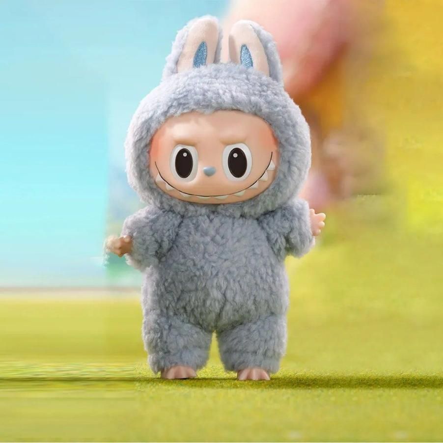 Labubu bunny doll gift dressed in fluffy gray bunny costume standing on green grass
