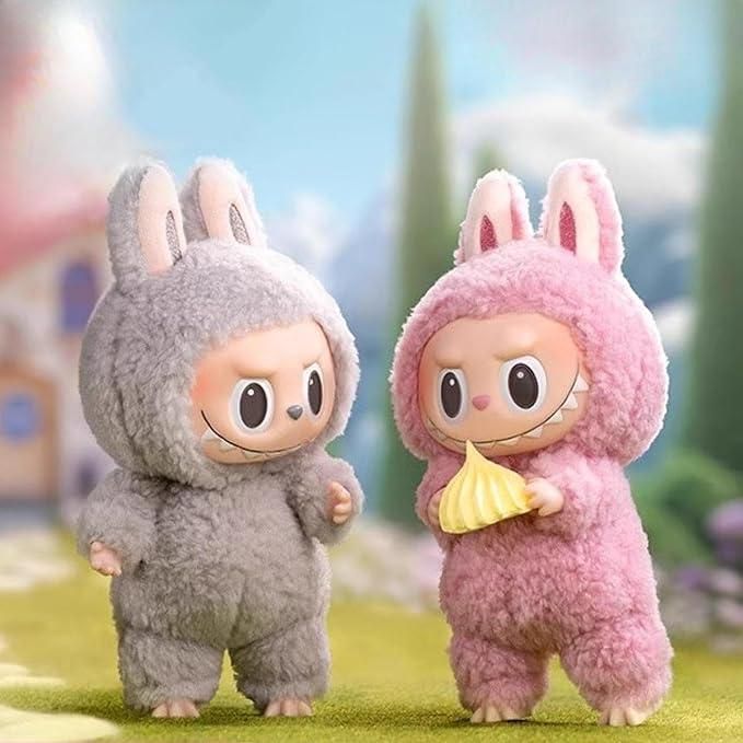 Two Labubu plush doll figures in gray and pink bunny costumes standing outdoors with a blurred background