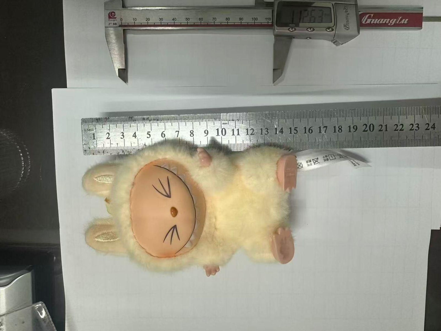 Labubu plush doll by THE GIR FARMER with cream fur and brown face measuring about 12 inches long