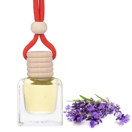 Lavender car air freshener in a glass bottle with a wooden cap and red cord, surrounded by lavender flowers