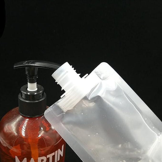 THE GIR FARMER leakproof travel pouches for liquids with white spout next to liquid soap dispenser