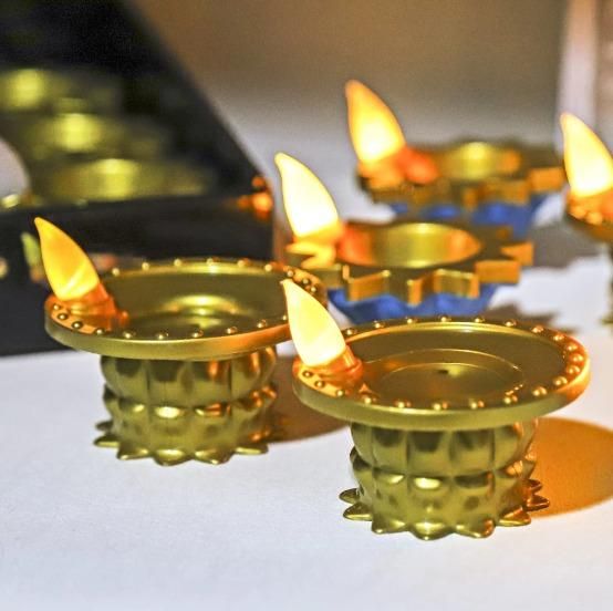 Decorative LED water pouring diya light with a golden finish, perfect for festive occasions