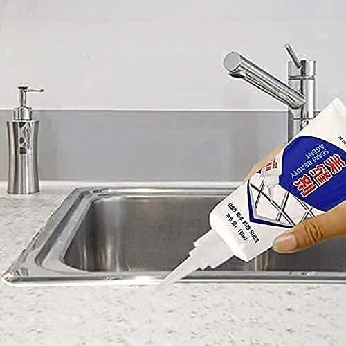 Bathroom tile crack repair adhesive being applied near a kitchen sink for tile crack fixing