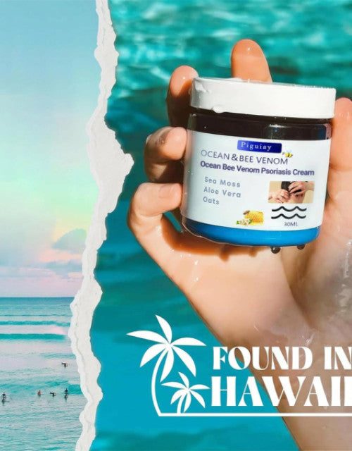 Dropdash Ocean Bee Venom Psoriasis Cream in a hand against a tropical beach background