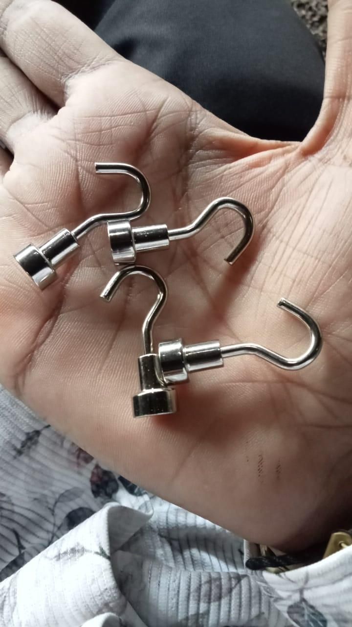 Hand holding three stainless steel heavy duty magnetic hanging hooks S shaped for tools and keys