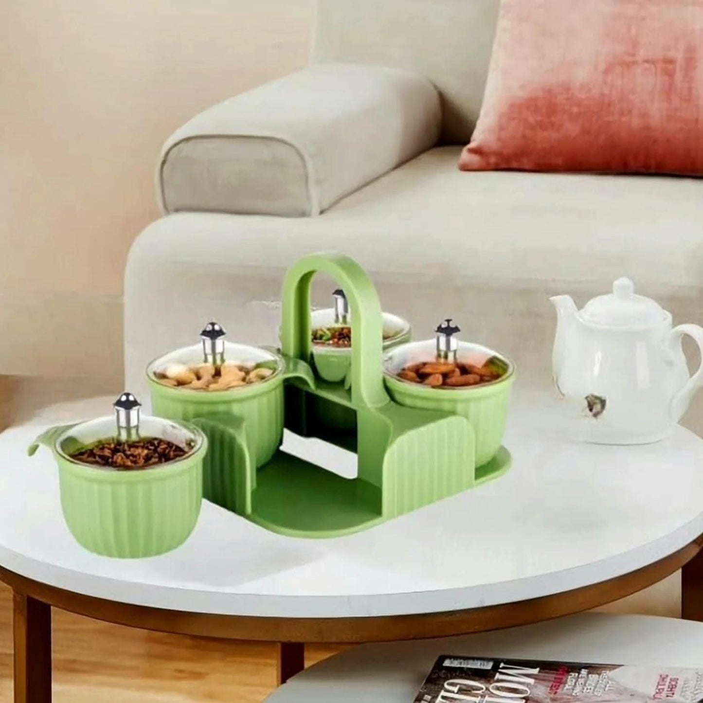 Green airtight snack jars for home with handle on white table holding nuts and snacks