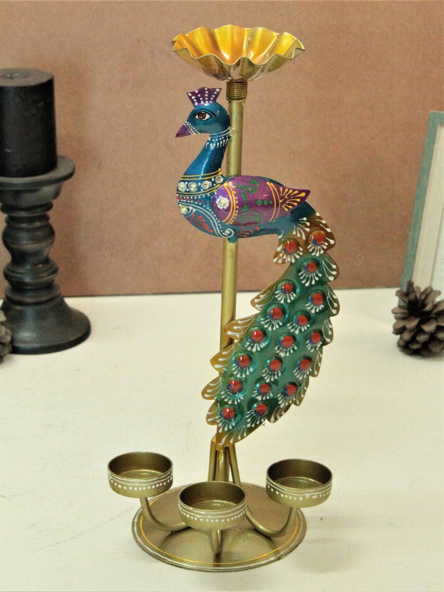 Colorful metal peacock tea light stand with detailed design and three candle holders by THE GIR FARMER