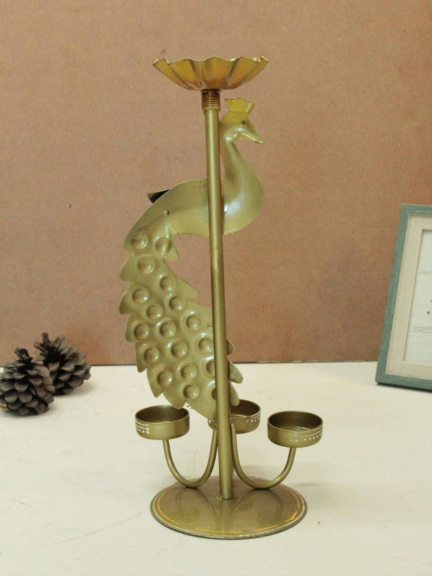 THE GIR FARMER metal peacock tea light stand with three holders and decorative tail design in brass finish