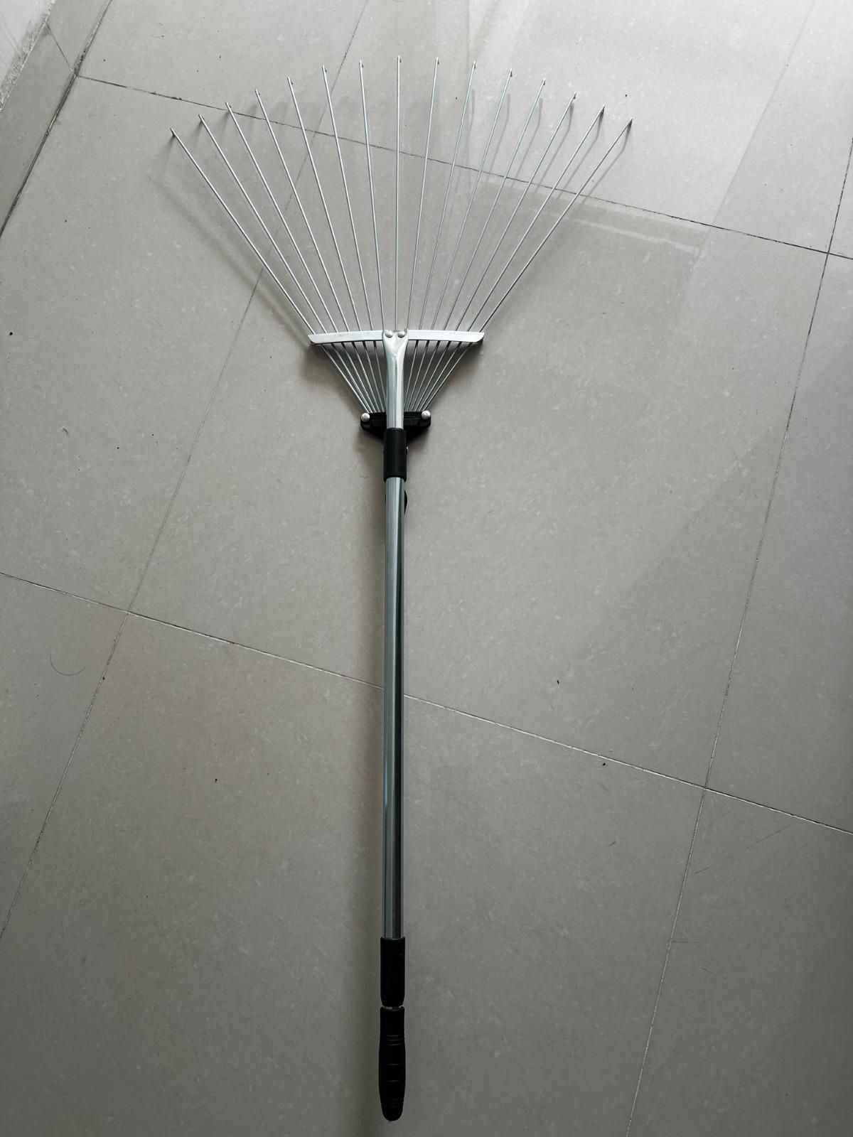 THE GIR FARMER metal yard rake for lawn care with long handle and wide metal tines on tiled floor