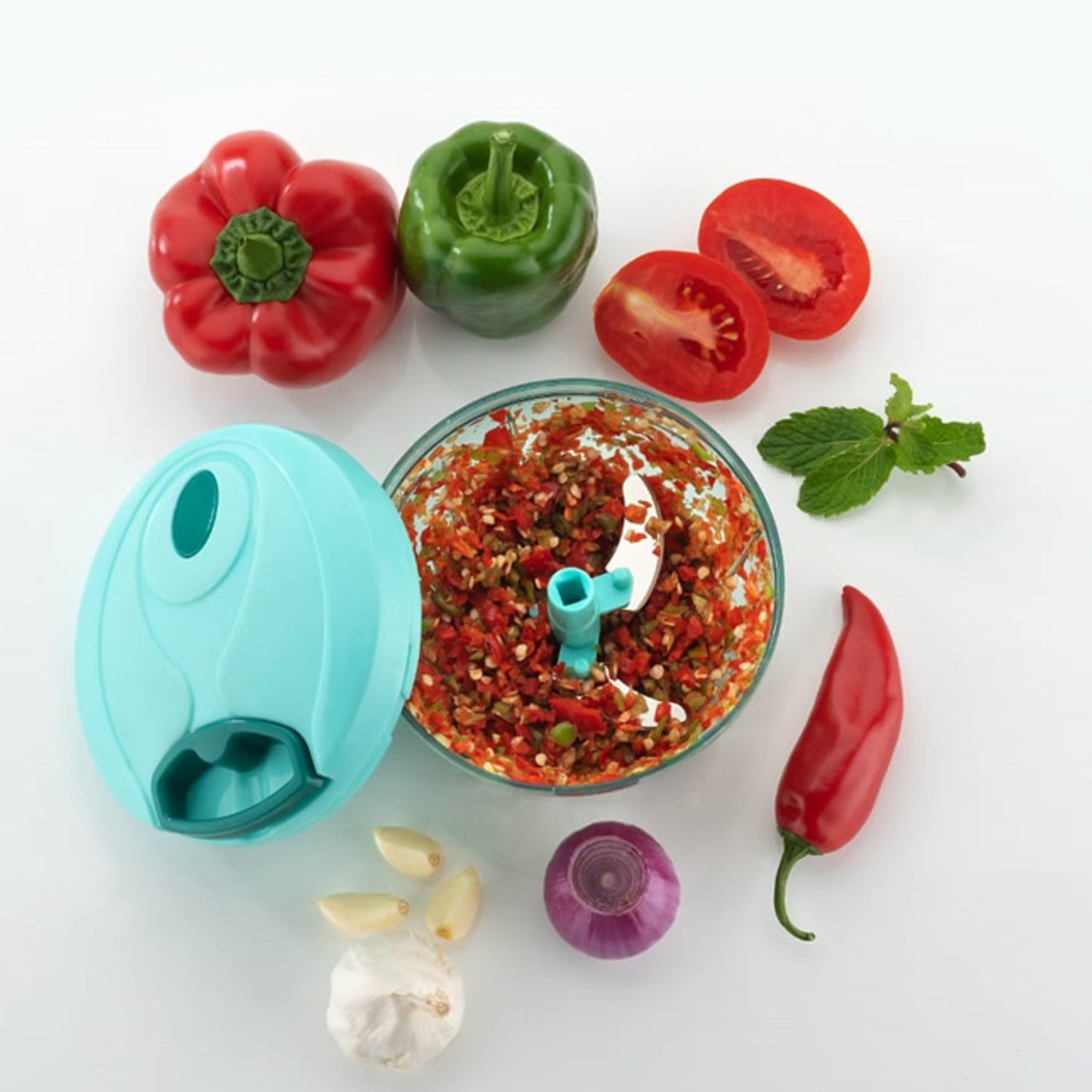 Wukusy mini vegetable chopper with chopped vegetables and fresh herbs, perfect for quick meal prep