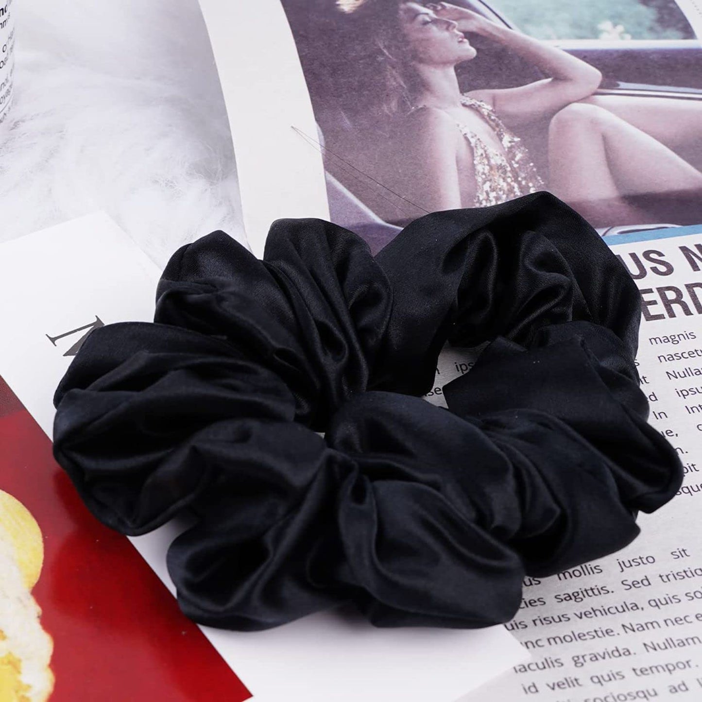 Black mulberry silk elastic band for hair by Amd-Deodap placed on magazine pages