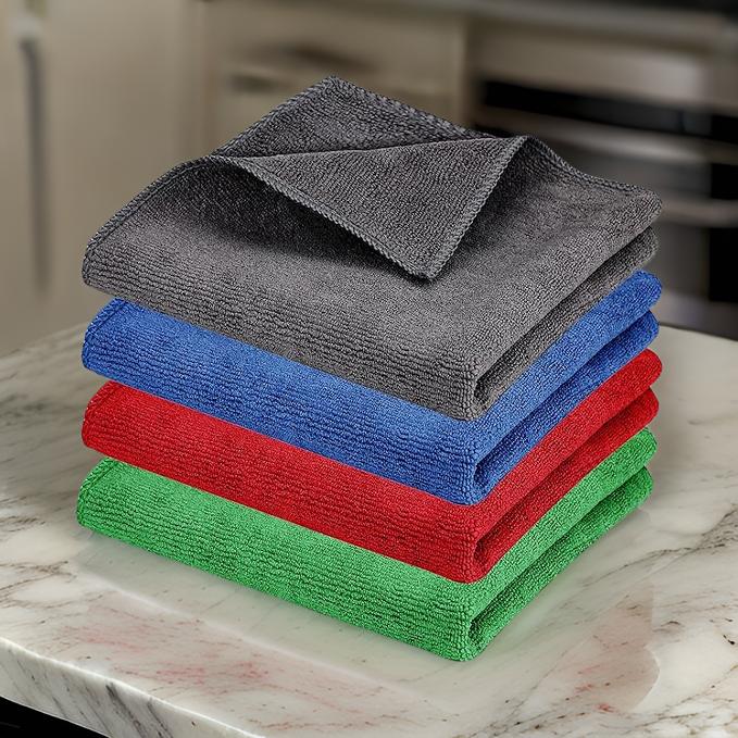 Set of colorful microfiber cloth for household cleaning stacked on marble countertop by THE GIR FARMER