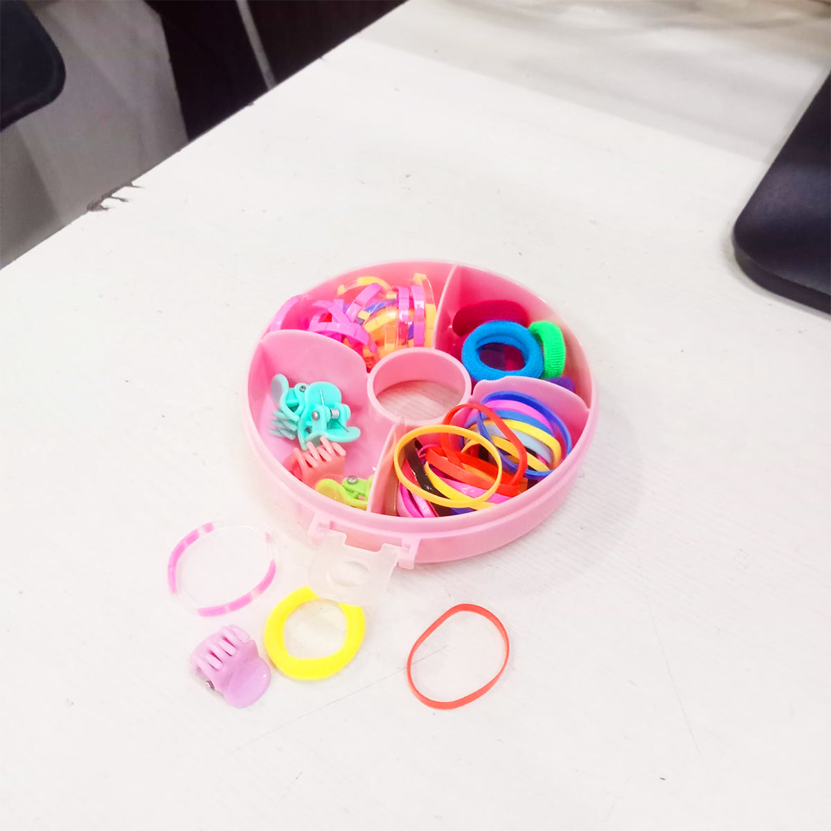 Amd-Deodap cute round hair accessories for girls in a pink divided storage case on a white surface