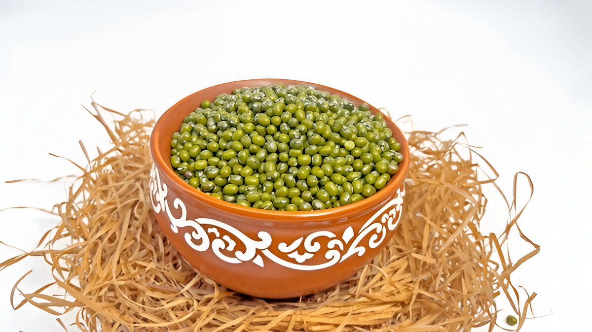 Organic green moong beans in a decorative clay bowl on natural straw by THE GIR FARMER