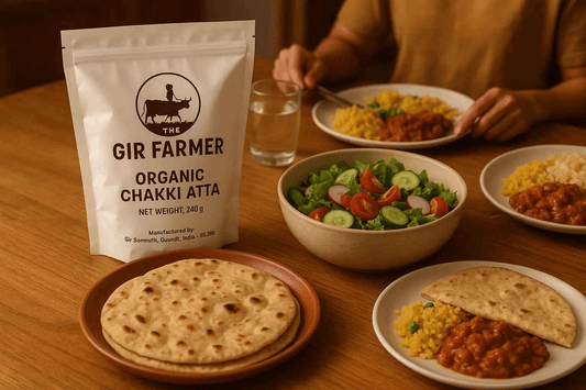 The Gir Farmer organic wheat flour in a bag with dishes of curry, salad, and flatbreads for a wholesome meal