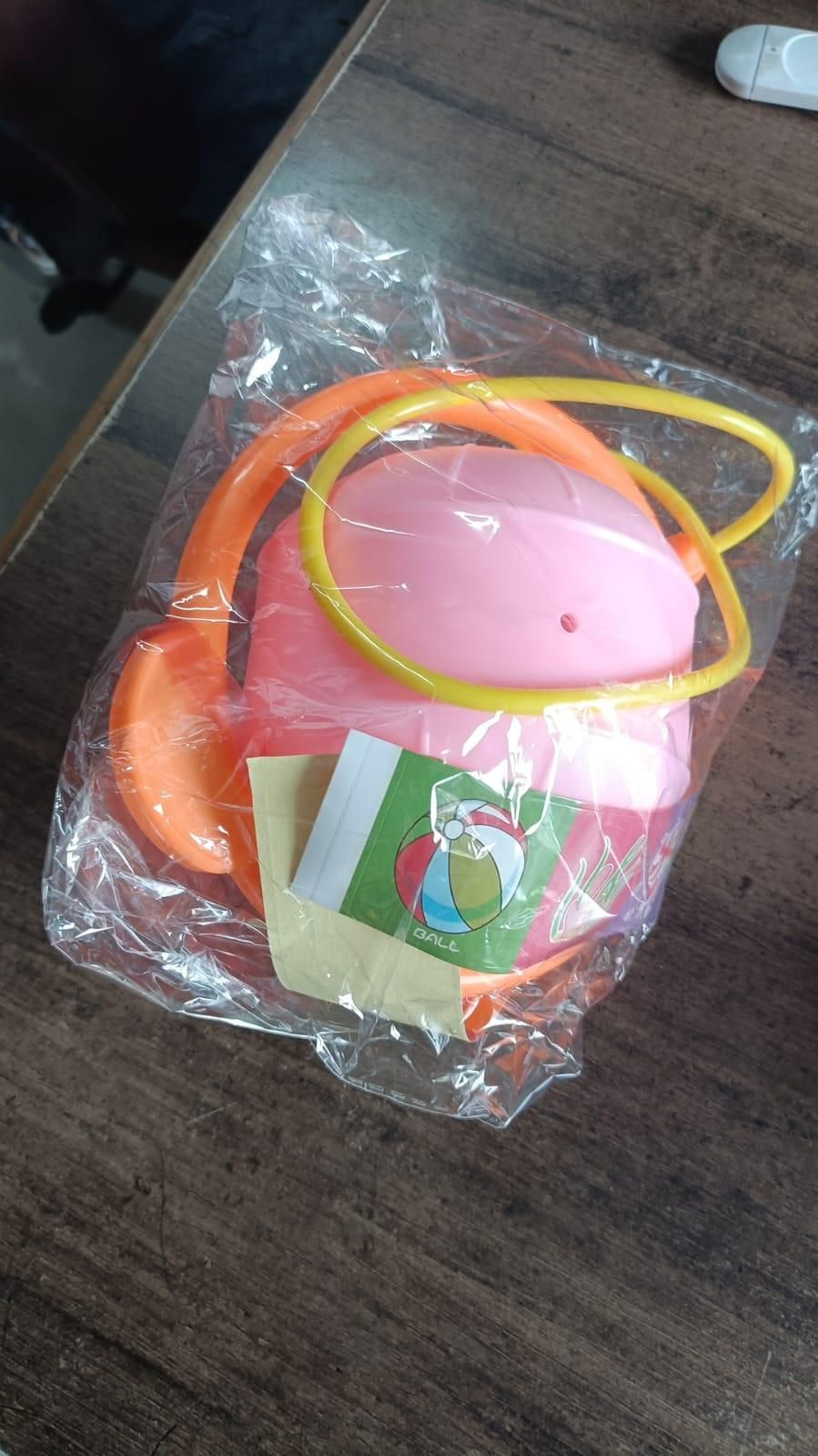 Pink and orange portable kids skip ball packaged in clear wrapping for outdoor fun