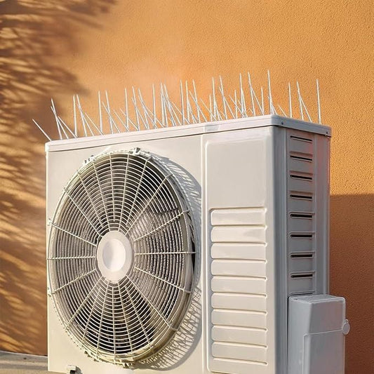 Pigeon control spikes set installed on an air conditioning unit to prevent nesting and roosting