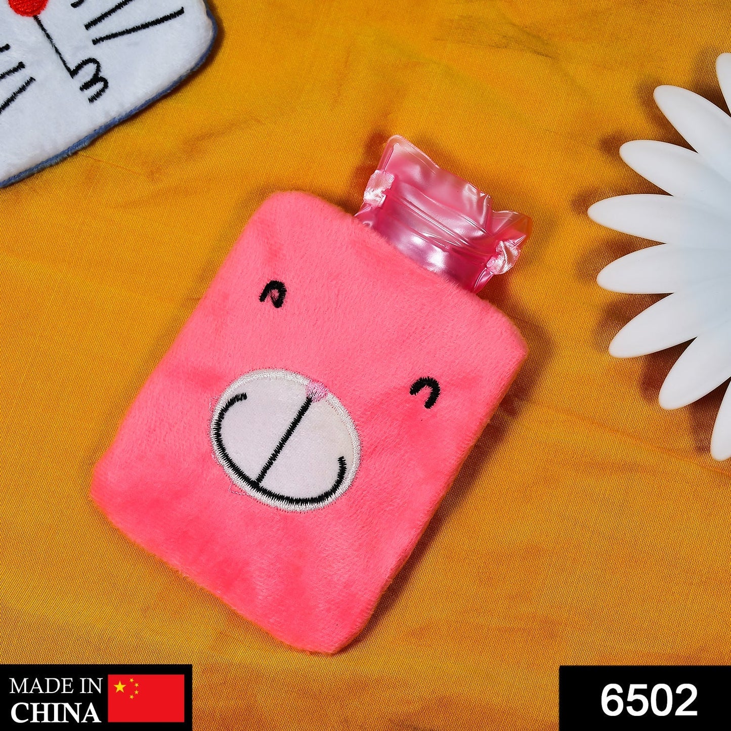 Pink hot water bag for cramps with a cute bear design and soft cover for maximum comfort