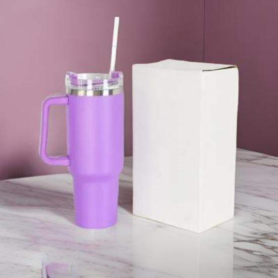 The Gir Farmer purple insulated sipper bottle with straw and handle clear lid with silver rim shown beside white box