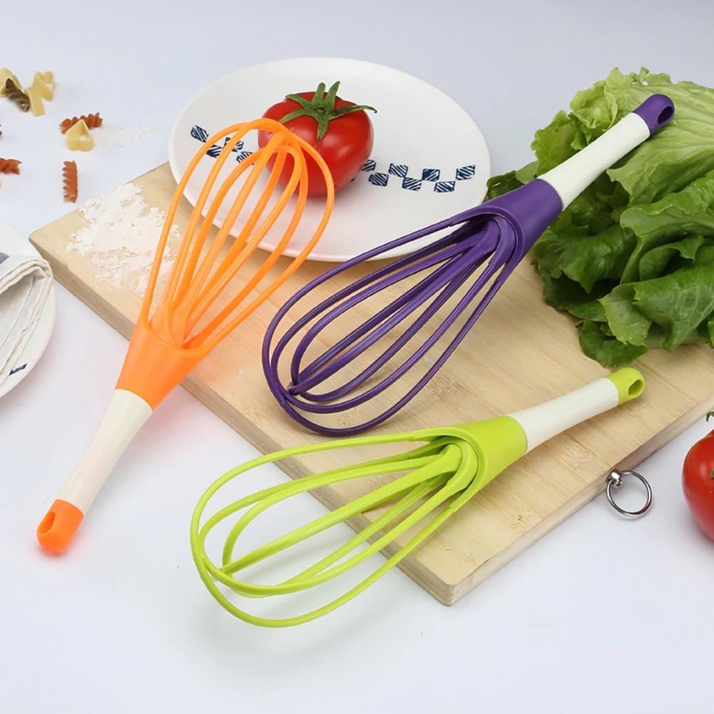 Colorful plastic balloon whisk mixer set in orange, purple, and green for efficient cooking and baking