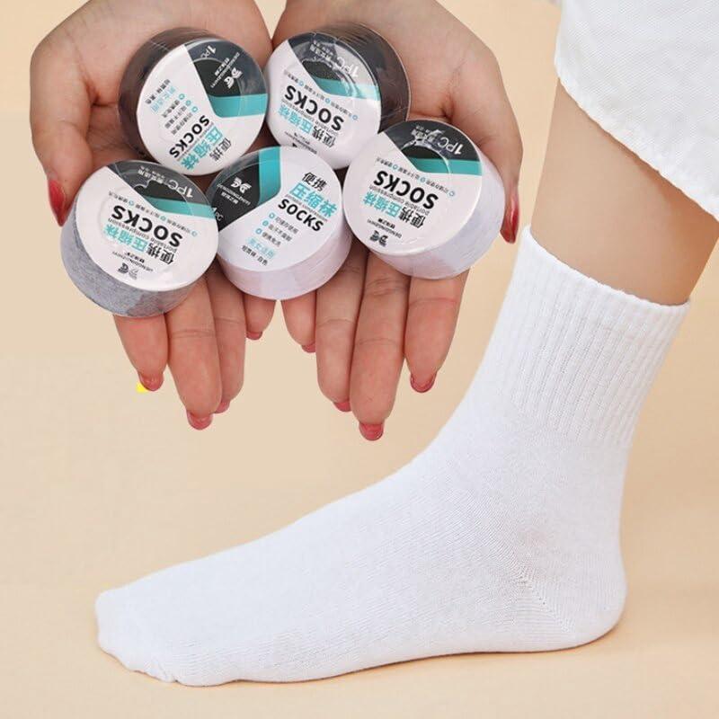Set of five portable disposable travel socks displayed in hands with one sock on foot for convenience