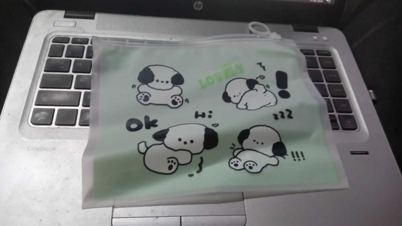 Cute reusable multipurpose pouch for kids featuring playful dog designs on a light green background