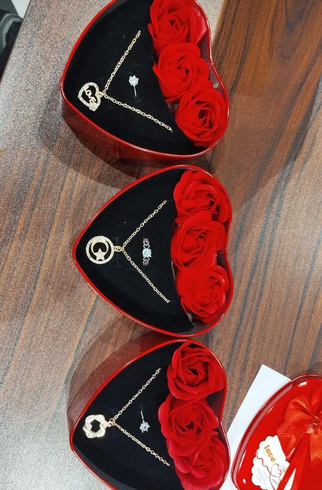 Romantic jewelry and flower combo with gold necklace and red roses in heart-shaped box by THE GIR FARMER