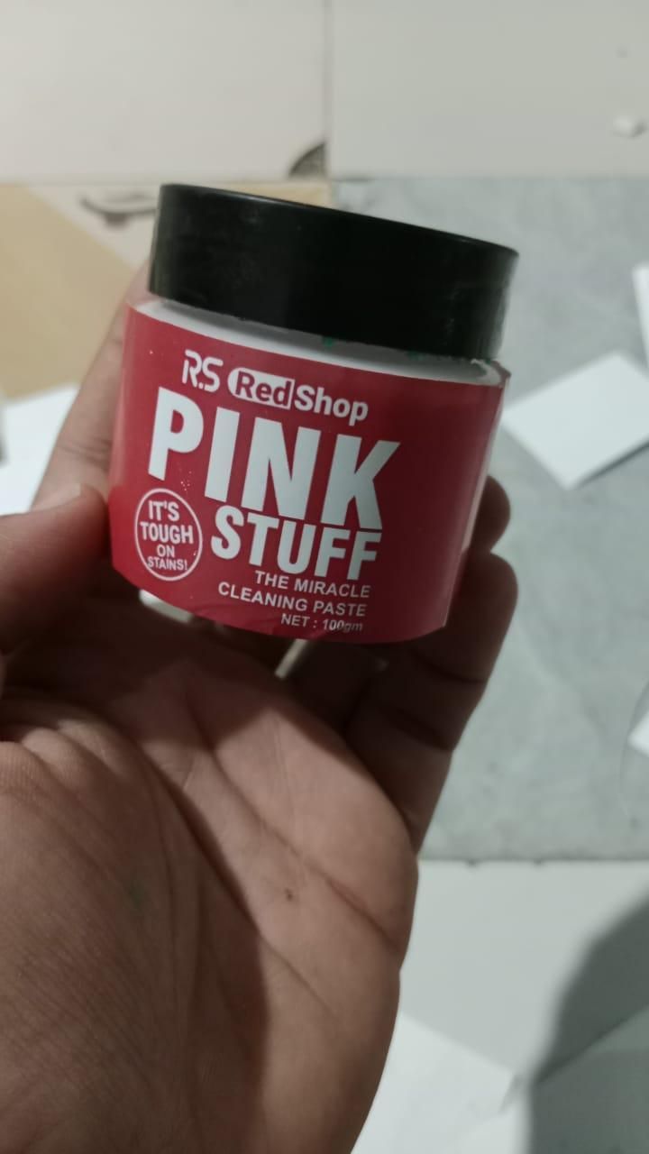 THE GIR FARMER Pink Stuff cleaning paste container labeled tough stain remover powder held in hand