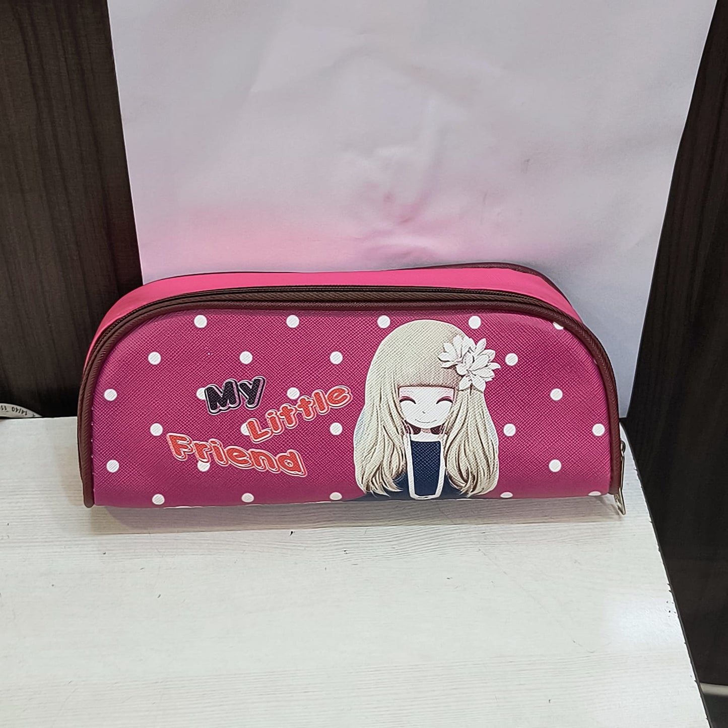 Pink school pencil case for children with white polka dots and cartoon girl design