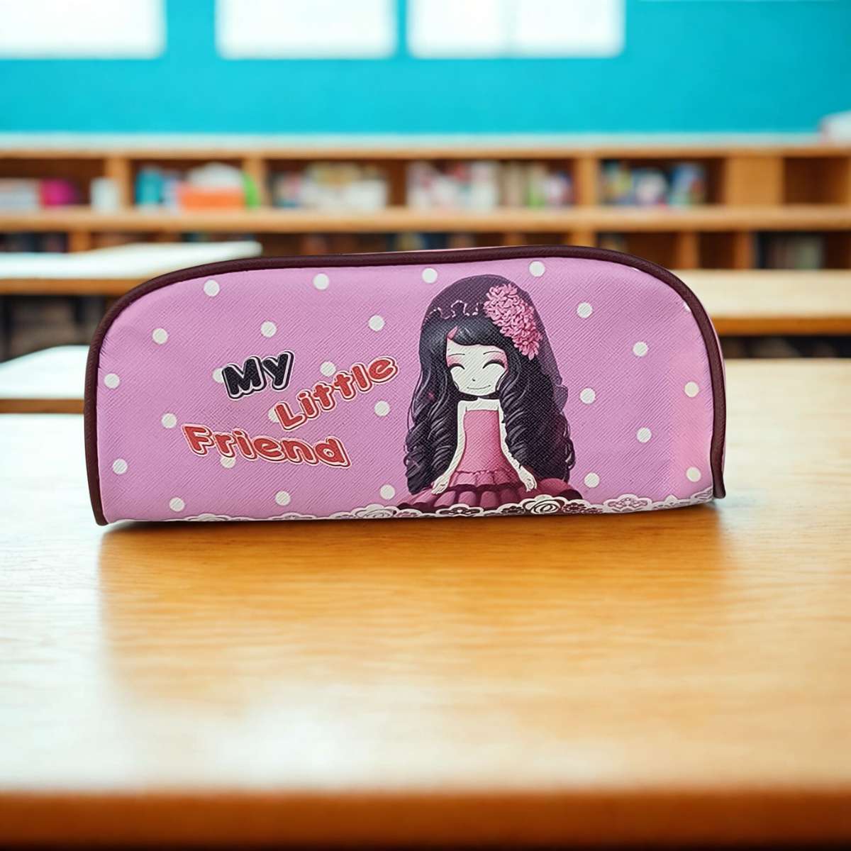 Pink school pencil case for children with cartoon girl and My Little Friend text on wooden desk