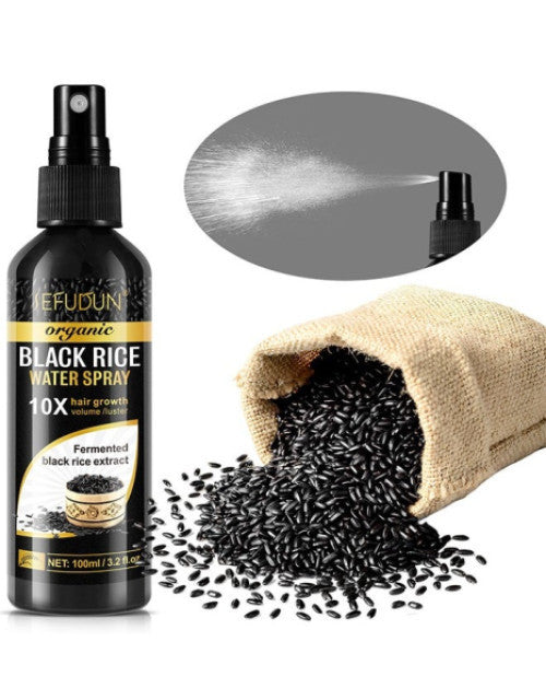 The Gir Farmer black rice water for hair growth spray bottle with spilled black rice seeds and mist spray demonstration