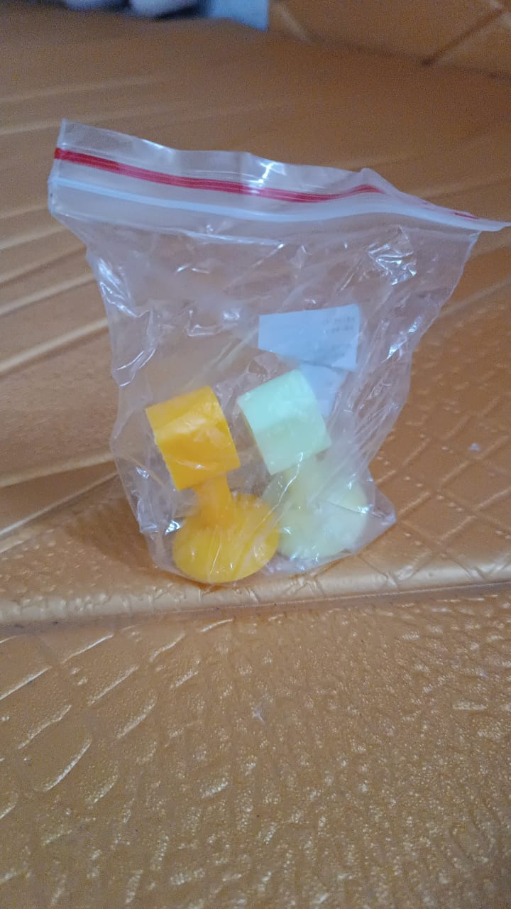 Self-sucking silicone door stopper in yellow and green stored in a clear plastic bag for home improvement