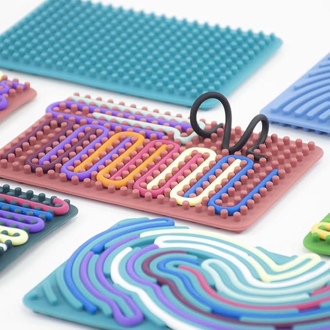 Colorful sensory development board for kids with textured pegs and movable loops for tactile play