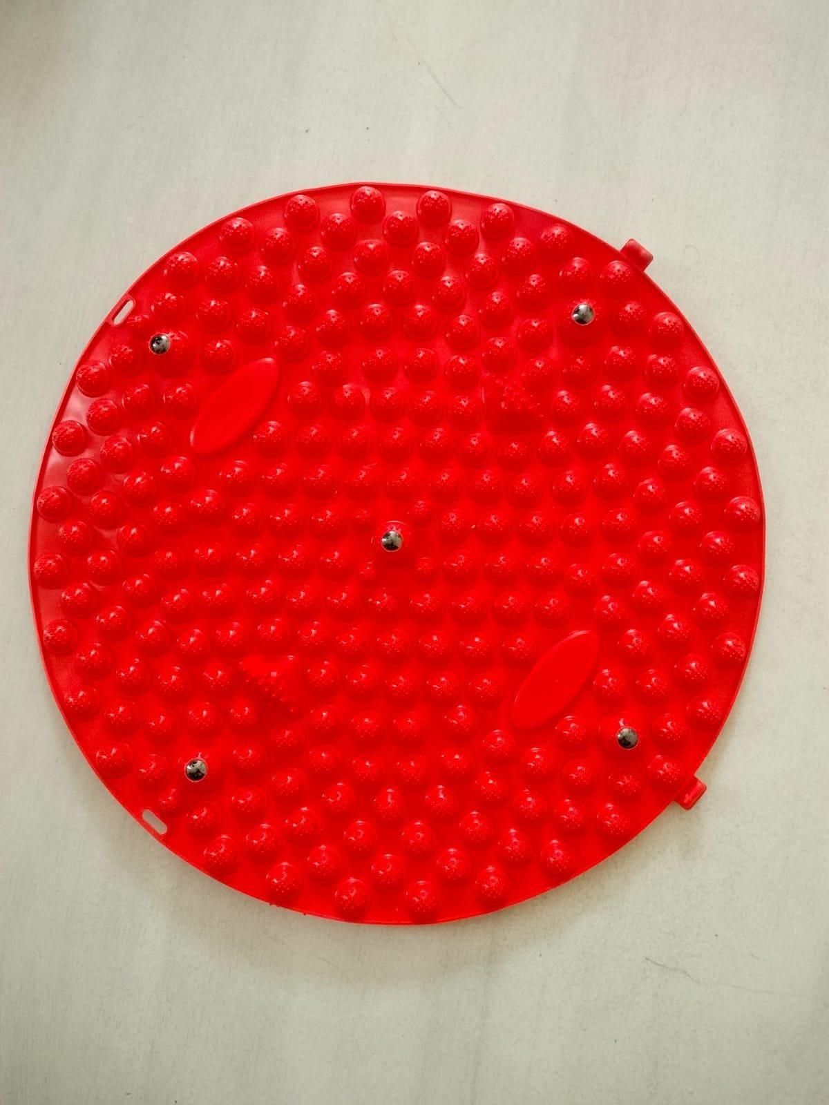 Red round silicone foot massage pad with raised nodes for stimulating and relaxing feet