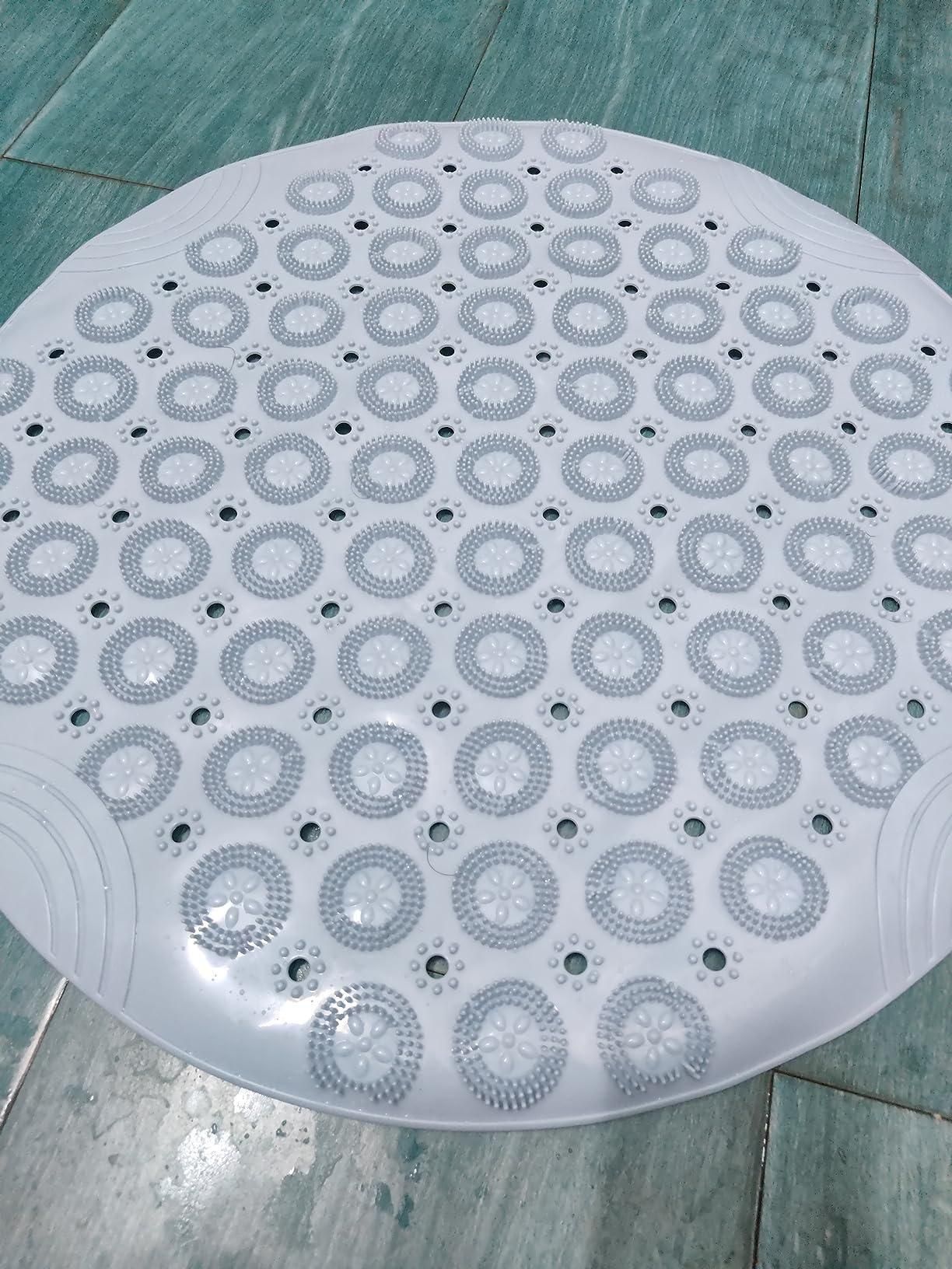 White silicone foot massage pad with textured circular nubs on tiled floor for foot relaxation