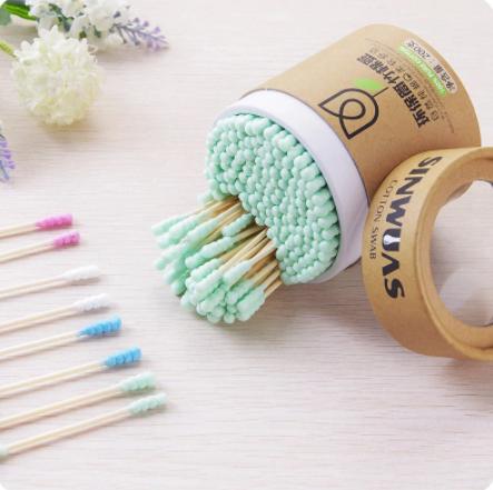Soft wood stick cotton swabs with light green tips in a round brown container from The Gir Farmer