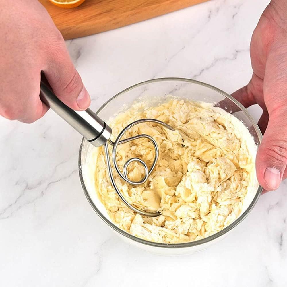 Dough mixer being used to mix dough in a glass bowl best kitchen tool for pizza dough mixing