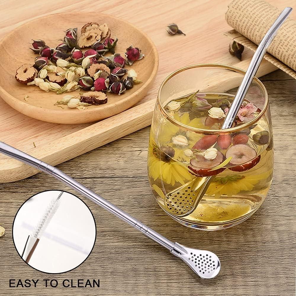 The Gir Farmer stainless steel drinking straws with built-in infuser and cleaning brush next to a glass of herbal tea
