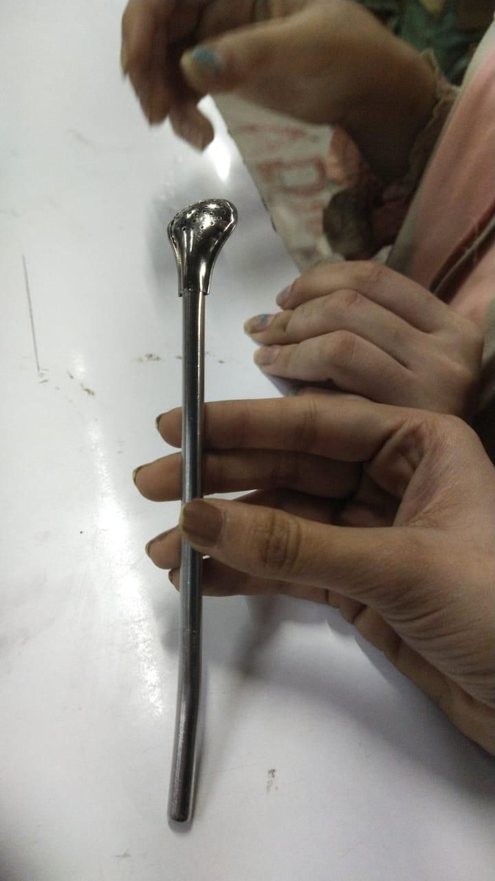 The Gir Farmer stainless steel drinking straws with a reusable bent design held in hand