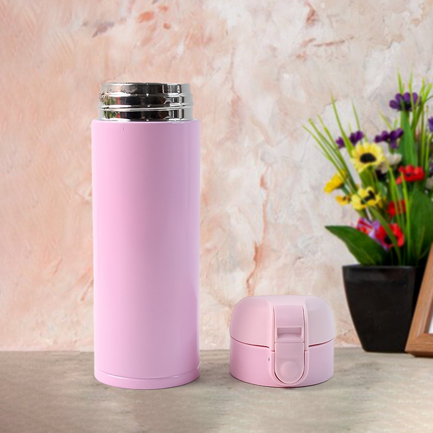 Wukusy stainless steel vacuum water bottle in pink with a matching lid, perfect for keeping drinks hot or cold.
