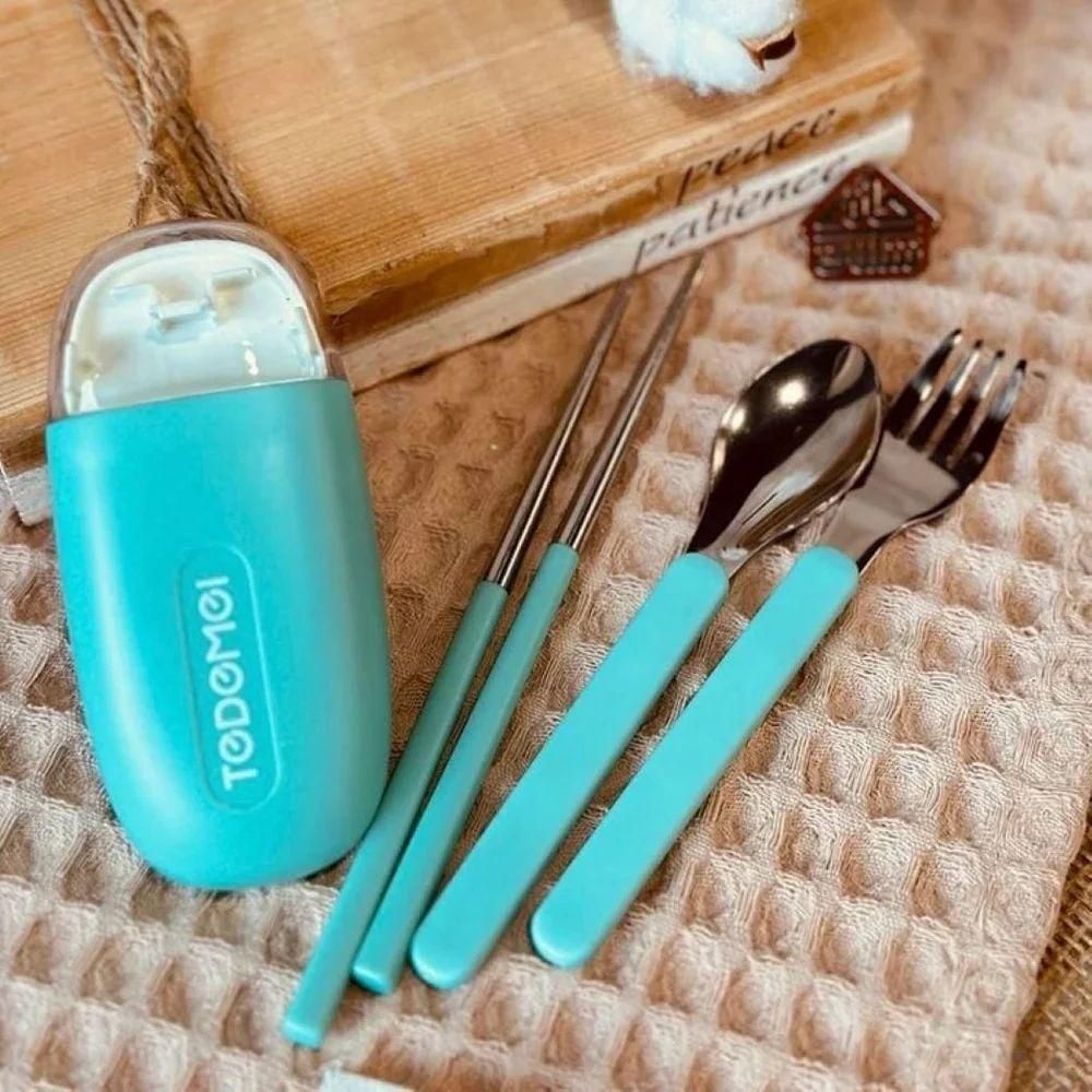 Blue travel cutlery set with chopsticks, spoon, fork, and carrying case on textured cloth