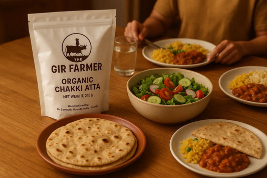 THE GIR FARMER Organic whole wheat flour packaging with dishes of Indian food on a wooden table