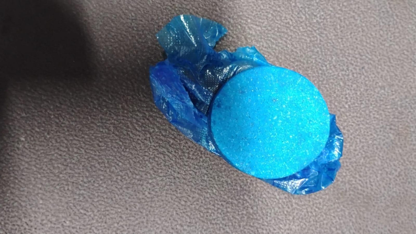 Bright blue toilet cleaning tablets wrapped in blue plastic by THE GIR FARMER