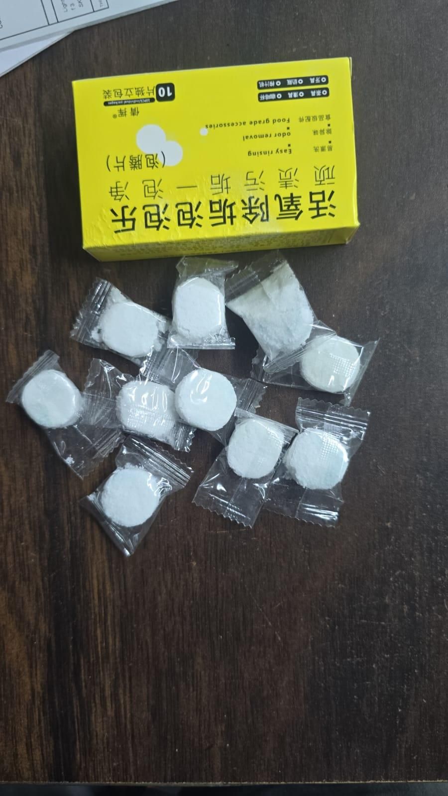 THE GIR FARMER toilet cleaning tablets individually wrapped with yellow box on wooden surface