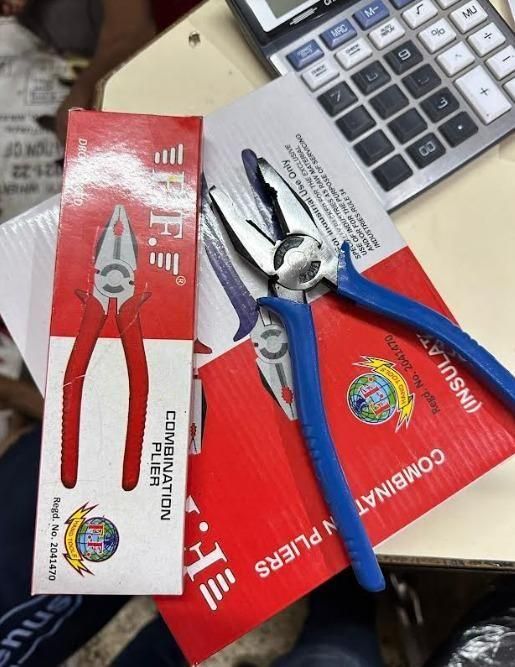 Combination pliers hand tool with blue handles and metal jaws on red packaging box