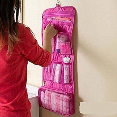 THE GIR FARMER pink travel makeup organizer bag hanging on wall with multiple compartments