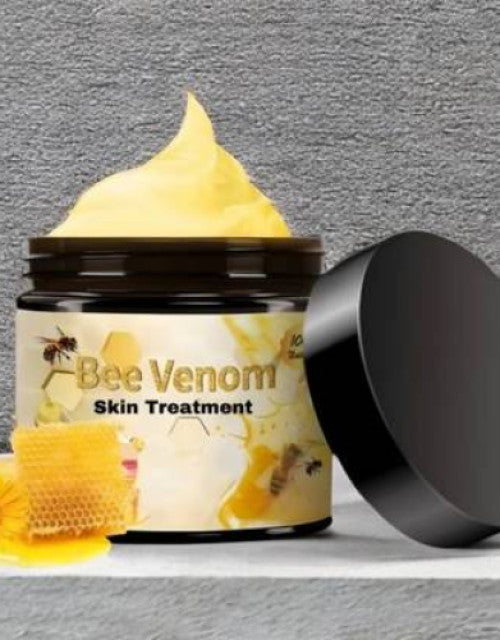 The Gir Farmer bee venom cream for acne scars in a jar with cream and honeycomb on gray background