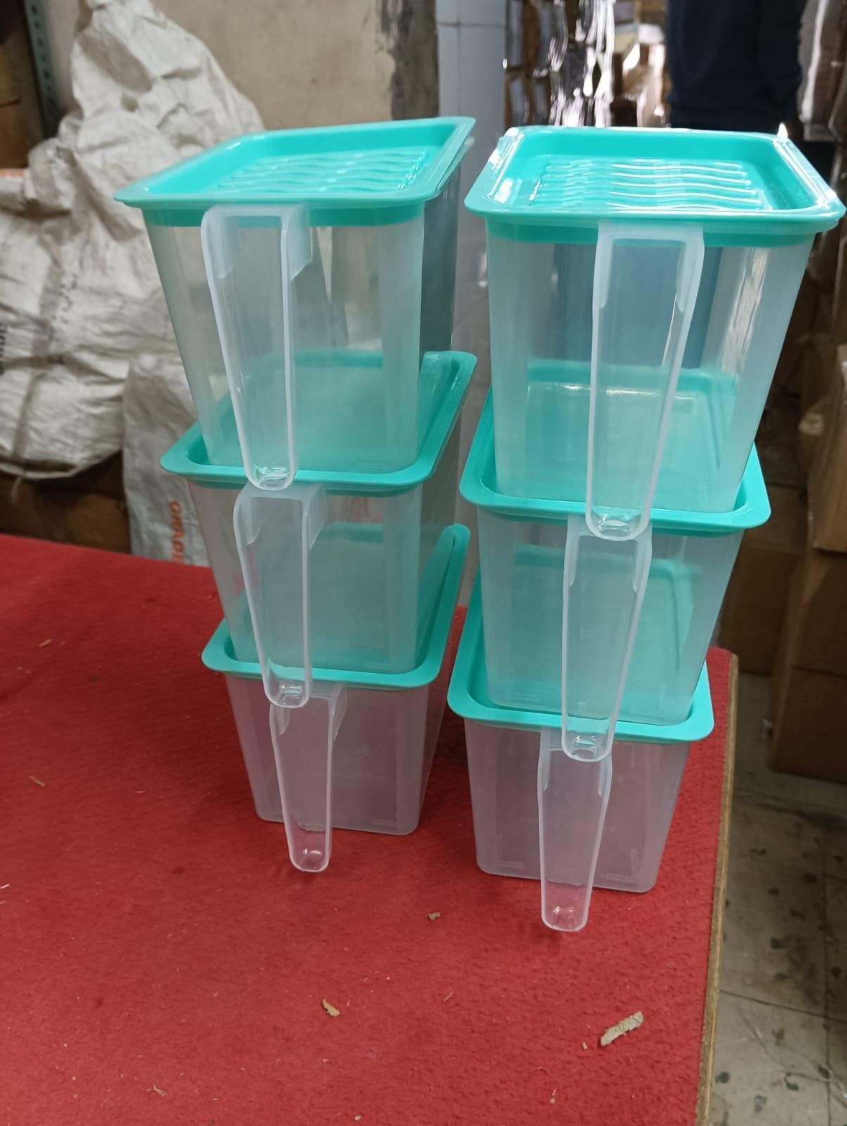 The Gir Farmer unbreakable kitchen storage basket set with clear containers and teal lids stacked on table