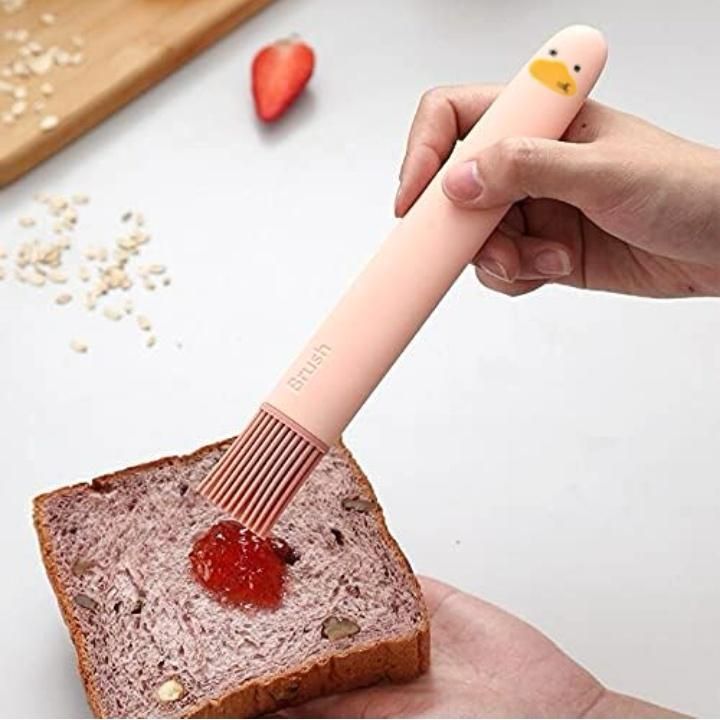THE GIR FARMER silicone pastry brush set with pink duck-shaped handle spreading jam on bread
